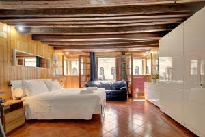 a bedroom with a large bed and a living room at Canal-Door in Venice
