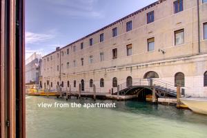 a view of a canal with a building and a bridge at Canal-Door in Venice