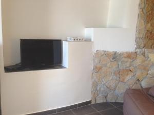 a living room with a flat screen tv on a wall at Gîte Polema in Marseille