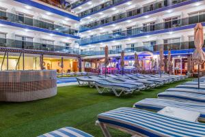 a pool on a cruise ship with chairs and umbrellas at Princesa Solar 4* - Adults Recommended in Torremolinos