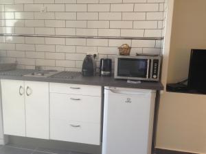 a kitchen with a counter with a microwave on it at Gîte Polema in Marseille