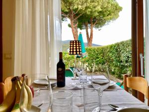 a table with a bottle of wine and glasses at Aviotel Residence in Marina di Campo