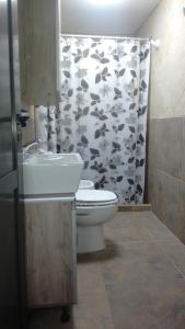 een badkamer met een toilet en een douchegordijn met koeien bij Los Talas in Villa Carlos Paz +10 foto's
