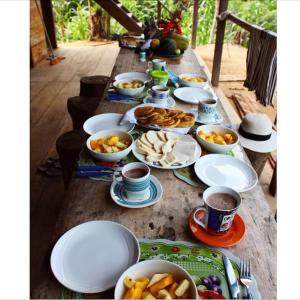 einen Tisch mit Teller mit Speisen und Tassen Kaffee in der Unterkunft Posada la Ofelia in El Zaino