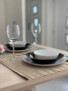 a table with plates and wine glasses on it at Studio Claudia in Opatija
