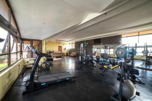 a gym with several treadmills and exercise bikes at 67 Airport Hotel Nairobi in Nairobi