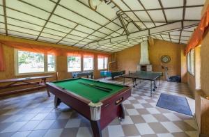 a pool table in a room with two tables at Pokoje Olech in Wrzosowo