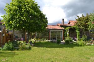 a house with a garden in front of it at studio indépendant dans maison à la campagne in Égliseneuve-près-Billom