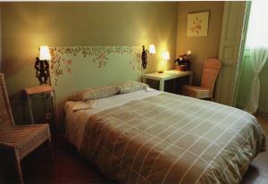 
a bedroom with a bed and a lamp at Hostal Fornos in Segovia
