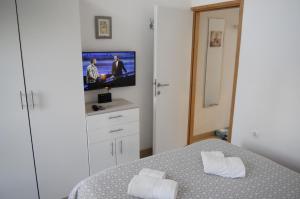 a bedroom with a bed and a flat screen tv at Apartment Mate in Zadar