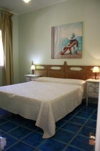 a bedroom with a bed and a painting on the wall at Luigi Apartments&Rooms in Pula