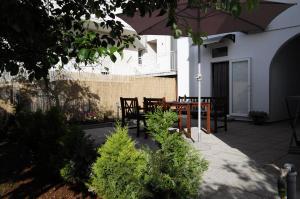 a patio with a table and chairs and an umbrella at Apartment Mate in Zadar