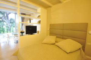 a bedroom with a bed and a tv in it at Villa Avellino Historic Residence in Pozzuoli +76 photos