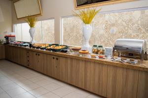 a buffet line with various types of food on it at Hotel Premier in São Luís