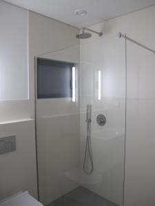 a shower with a glass door in a bathroom at Canto do Nemo in Canto da Areia +29 photos