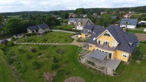 an aerial view of a house with a yard at Agroturystyka nad Wielkim Szelągiem in Stare Jabłonki