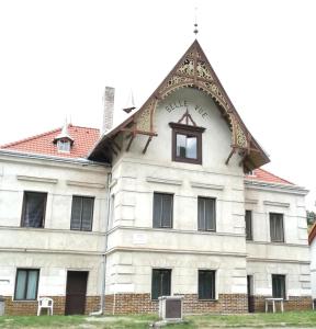 a large white building with a clock on it at Pronájem pokojů Belle Vue in Vranov nad Dyjí