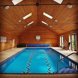 a large indoor swimming pool in a building at Kilmokea Coach House in New Ross