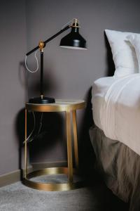 a lamp sitting on a table next to a bed at Creekside Villa in Canmore