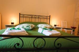 a bed with two towels and two pillows on it at CASA CAIROLI PUTIGNANO in Putignano