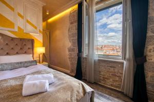 a bedroom with a bed and a large window at Riva Palace - design rooms in Zadar