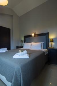 a bedroom with a bed with two towels on it at Villa Elaia Suites & Apartments No.1 in Gaios