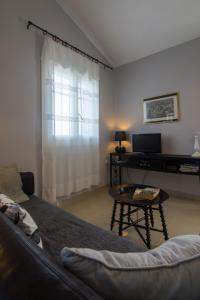 a living room with a couch and a table at Villa Elaia Suites & Apartments No.1 in Gaios