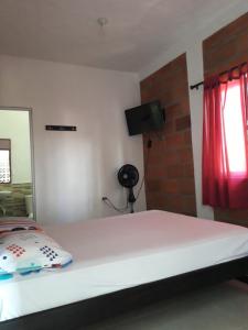 Ein Bett oder Betten in einem Zimmer der Unterkunft Hostal finca Palermo