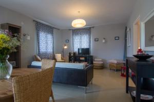 a living room with a couch and a table at Villa Elaia Suites & Apartments No.2 in Gaios
