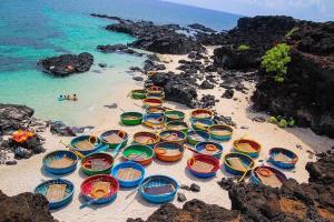 a group of colorful boats sitting on a beach at HOMESTAY LOAN ANH in Ly Son