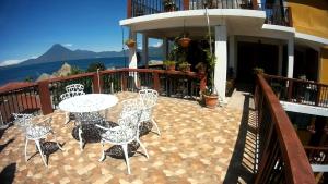 een patio met een tafel en stoelen op een balkon bij Hotel Sueño Real in Panajachel