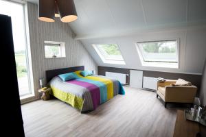a bedroom with a bed and two windows at B&B Groot Pepersgoed in Hoevelaken