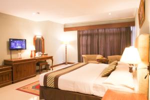 Krevet ili kreveti u jedinici u okviru objekta Cakra Kusuma Hotel