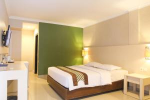 Krevet ili kreveti u jedinici u okviru objekta Cakra Kusuma Hotel