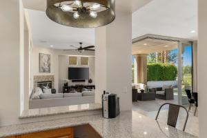 a kitchen and living room with a couch and a television at PGA West Golf Course Pool & Spa Home in La Quinta