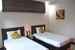 A bed or beds in a room at Kong Garden View Resort Chiang Rai
