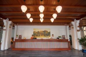 a lobby with a bar with lights on the ceiling at Vinh Hung Old Town Hotel in Hoi An +64 photos