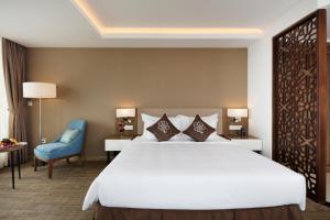 Postel nebo postele na pokoji v ubytování Comodo Nha Trang Hotel