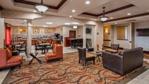a lobby with chairs and tables and a bar at Best Western PLUS Memorial Inn in Oklahoma City