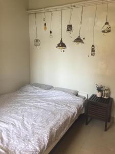a bedroom with a bed and several pendant lights at YHA Ngong Ping SG Davis Youth Hostel in Hong Kong