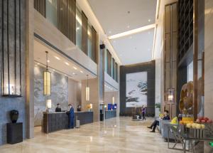 a rendering of the lobby of a hotel at Shenyang Huaqiang Novlion Hotel in Daoyi