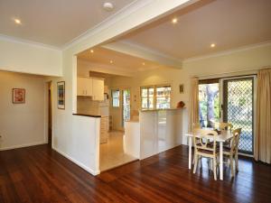 a kitchen and living room with a table and chairs at Summer Cottage in Hawks Nest