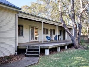 a porch of a house with a wooden deck at Summer Cottage in Hawks Nest