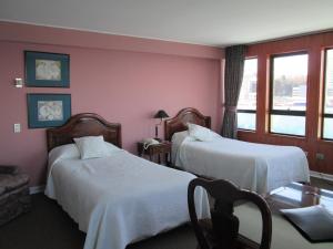 Postel nebo postele na pokoji v ubytování Hotel Apart Colón