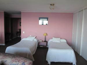 Postel nebo postele na pokoji v ubytování Hotel Apart Colón