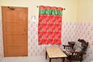 a room with a red curtain and a table at Hotel Ganesh Lodge in Kanyakumari