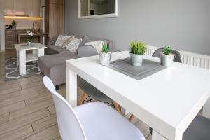 a living room with a white table and chairs at Apartament Grey in Mielno