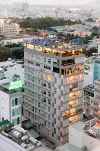an aerial view of a tall building in a city at Maple Leaf Hotel & Apartment in Nha Trang