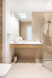 a bathroom with a sink and a shower at Hotel Platan in Gdańsk