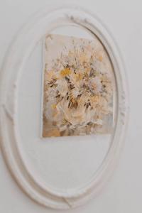 a painting of a flower in a mirror at Centro SPA Atostogų namai in Birštonas